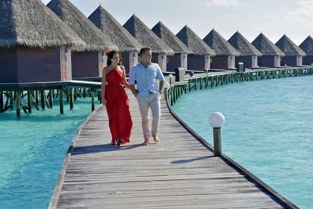 Maldives resort owerwater villa with a honeymoon couple